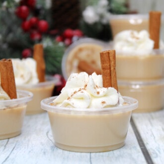 Eggnog Jello Shots on a white wooden table.