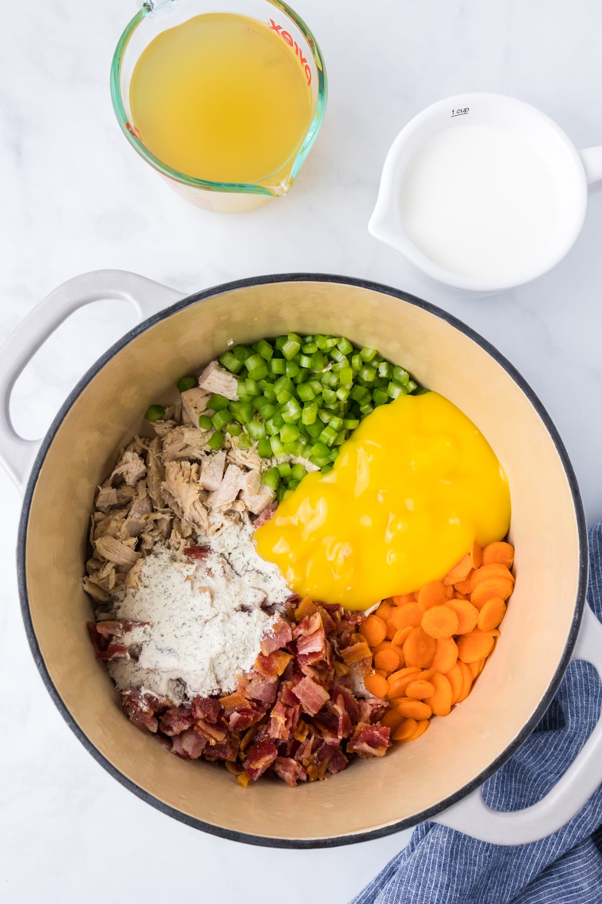 Vegetables, chicken noodle soup, and bacon in a pot